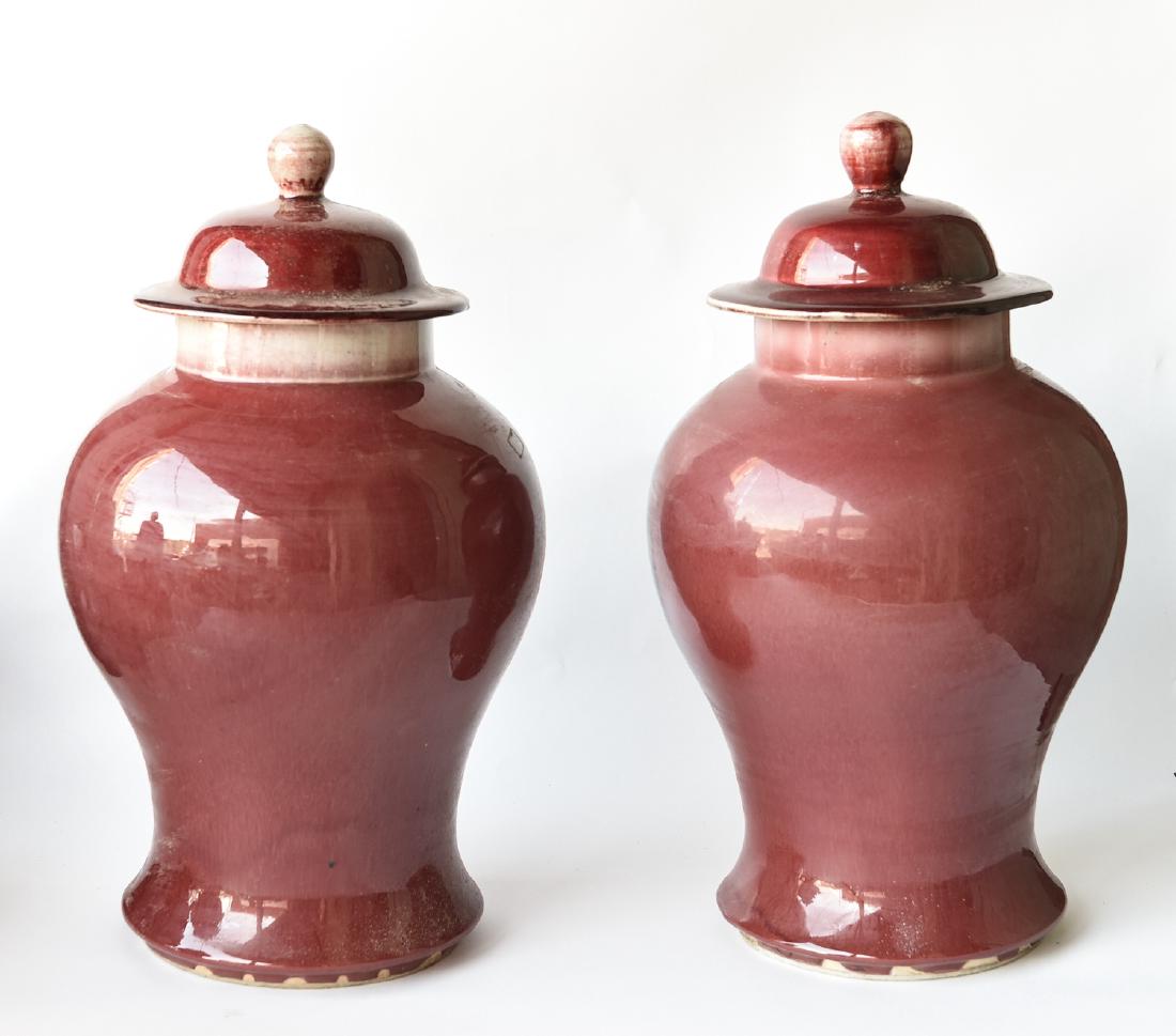 19TH C. CHINESE PORCELAIN OX BLOOD TEMPLE JARS: Dimensions: H 18" x W 10" Condition: One with a dime size flaw in the making.