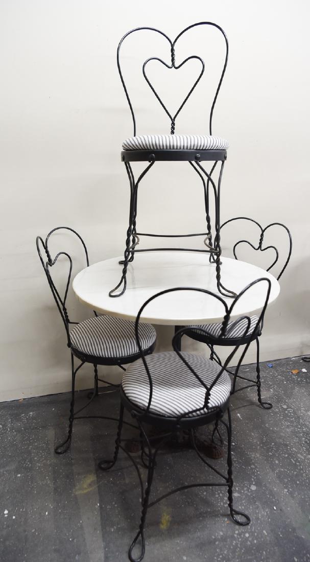 IRON AND MARBLE BISTRO SET: Dimensions: (Table) H 29" x Dia. 30" Condition: Few surface scratches and flea bites to edges of marble.