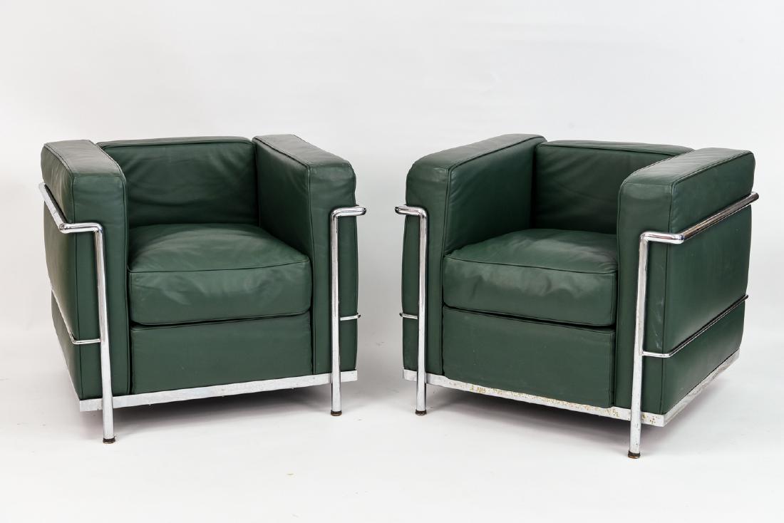 PAIR OF CLUB CHAIRS MANNER OF CORBUSIER: In the manner of LE CORBUSIER LC2 In Vitello fiore #7 green. Dimensions: H 26.5" W 28.5" D 29" Condition: Very light wear to upholstery consistent with use. Some pitting and small areas of rust to bas