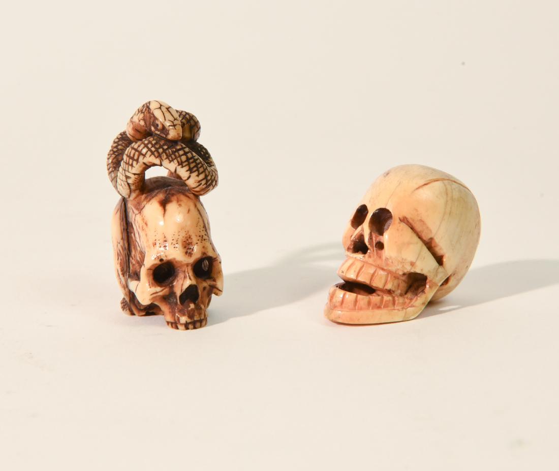 (2) 19TH CENTURY BONE SKULL NETSUKE SCULPTURES: Dimensions: (Taller) H 2" x W 1.25"x W 1" Condition: Wear consistent with age. Few hairlines.