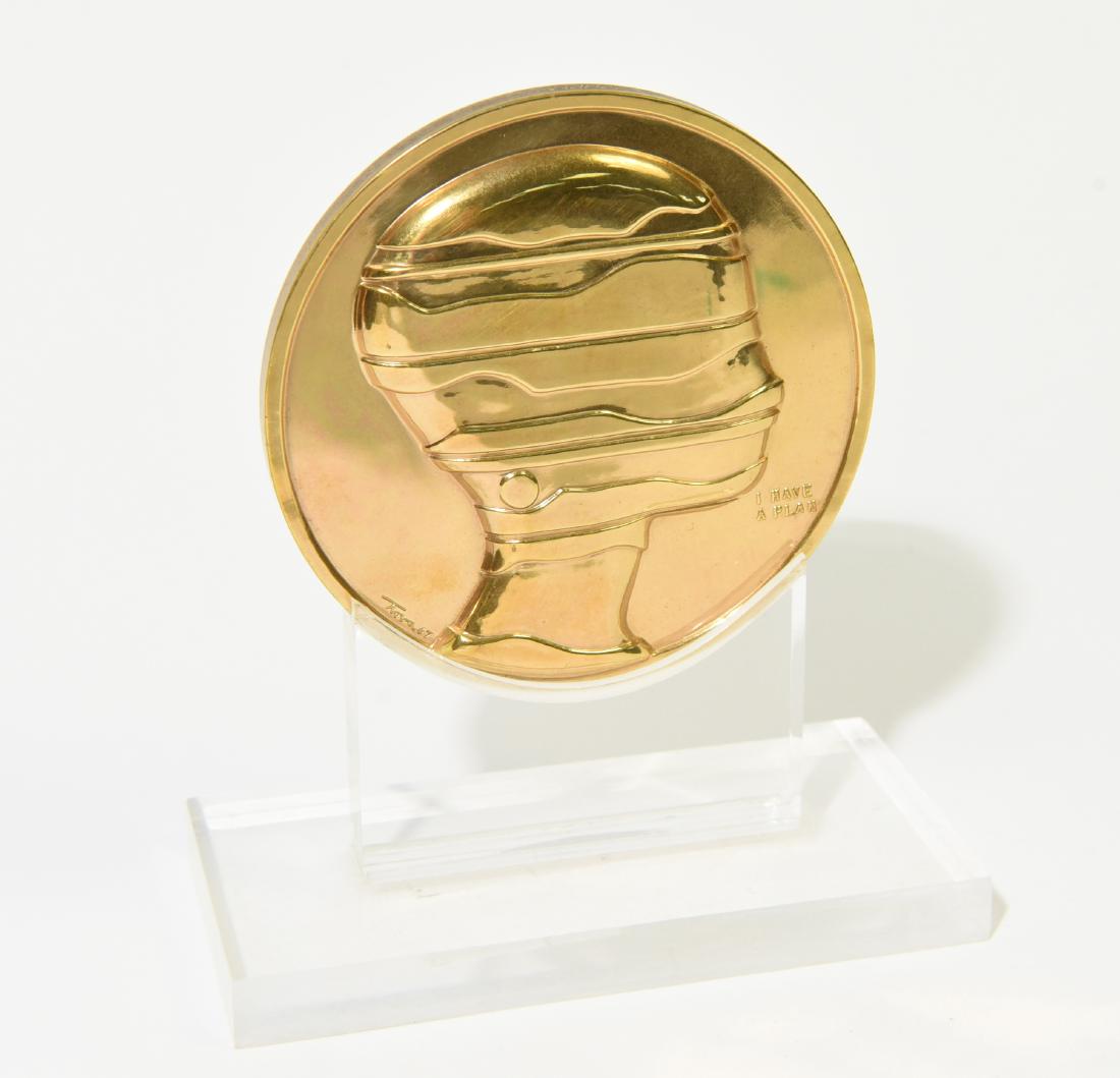 1967 ERNEST TROVA MANSCAPE BRONZE MEDALLION: On lucite stand. Dimensions: (On stand) H 6" x W 5" x D 2.75" Condition: No issues to note