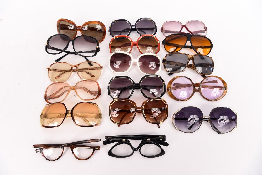 GROUPING OF VINTAGE EYE GLASSES: Including: Corning, Foster-Grant, Blueblocker, and ROC. Count: 17 pairs Condition: Vintage wear consistent with age and use. As is.