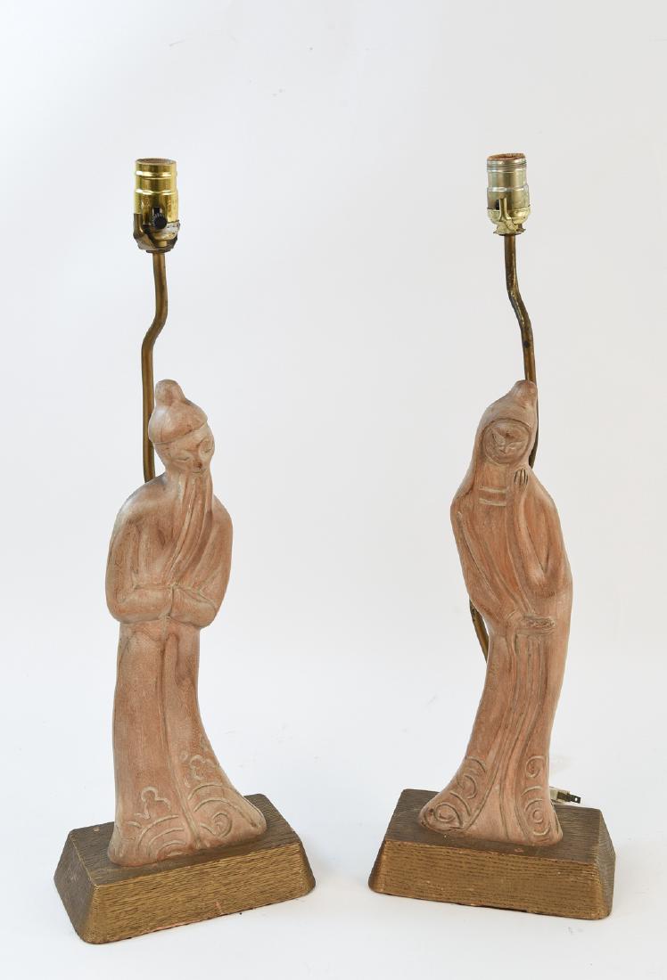 PAIR OF YASHA HEIFETZ CARVED WOOD LAMPS: Marked Heifetz to back of one. Dimensions: H 24.5" x W 8" x D 5" Condition: Some light marks and wear to figures, bases show moderate wear and marks.