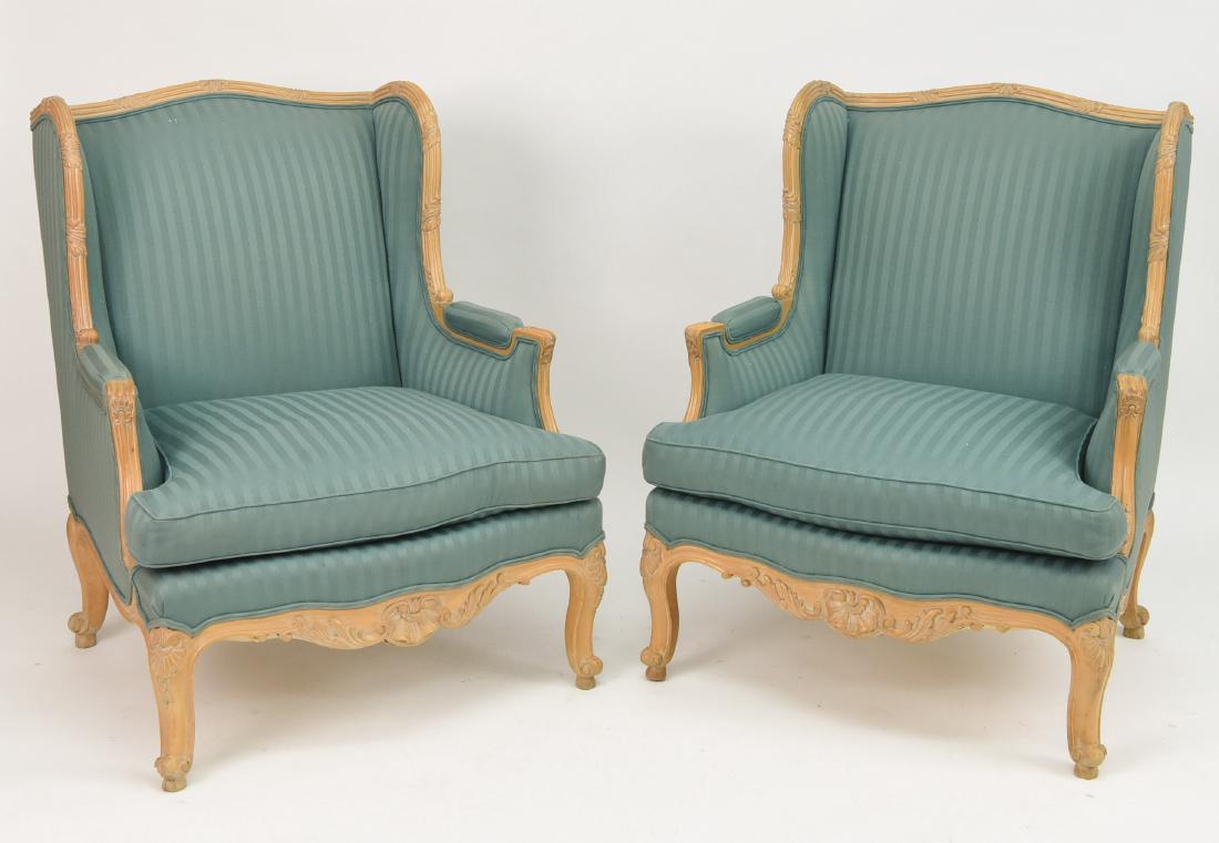PAIR OF DEVON LOUIS XVI STYLE WINGBACK CHAIRS: Dimensions: H 42" x W 48" x D 36" Condition: Some wear consistent with age and use. Some nicks, dings, and scuffs to base. Few small marks and holes to upholstery.