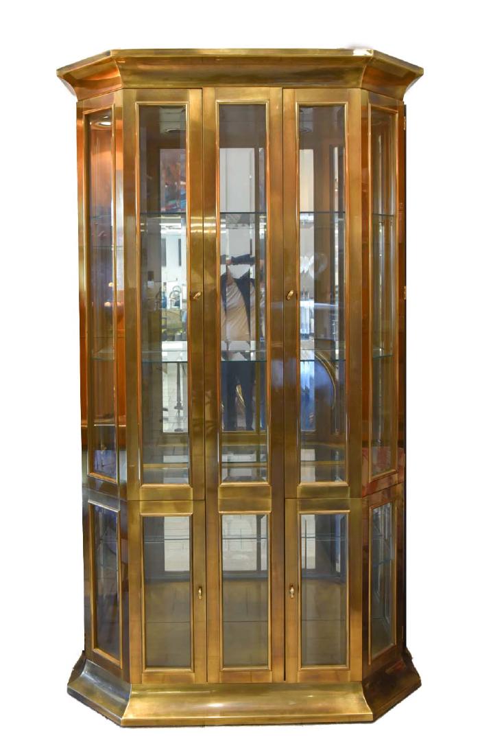 MASTERCRAFT BRASS AND GLASS VITRINE CABINET: Has working electric light fixture. Features mirrored back and beveled glass in doors. Dimensions: H 81.75" x W 47" x D 19.25 Condition: Few mild scuffs.