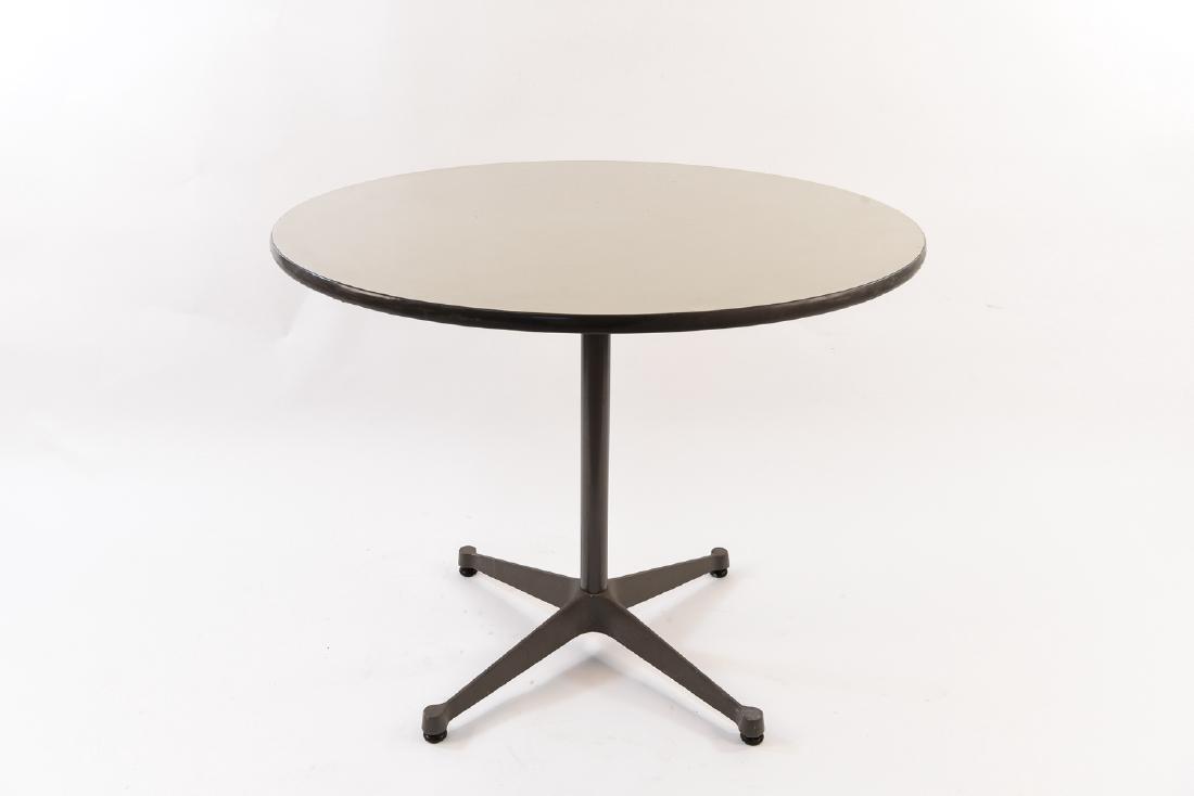 HERMAN MILLER TABLE: With tag underneath.Dimensions: H 28.75" x D 35.5"Condition: Some scratches and water stains to surface. Some wear and scuffs to edges/trim. Some finish wear to base.