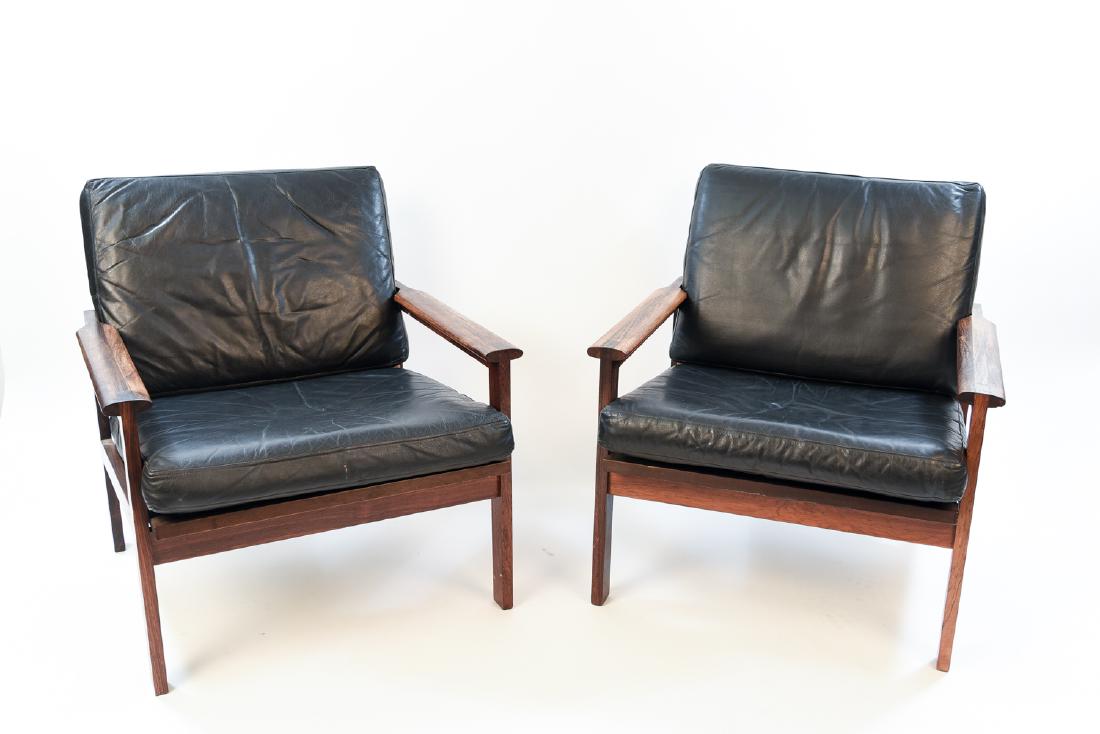 PAIR ILLUM WIKKELSO ROSEWOOD & LEATHER EASY CHAIRS: Designer Illum WikkelsÃ¸, Model Capella by Niels Eilersen in Denmark, mid-century. Dimensions: H 29" x W 27" x D 28" x SH 15.5" Condition: Minor scratching if any to the frames, may need new rubber