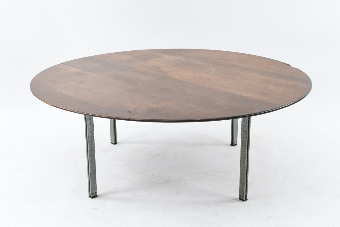MID-CENTURY FLAT BAR LEG COFFEE TABLE: Dimensions: H 15.5" x Dia. 42" Condition: Finish loss. Surface scratches, scuffs, and gouges. Loss to wood on edge of table top. Wear around edges. Oxidation to legs.