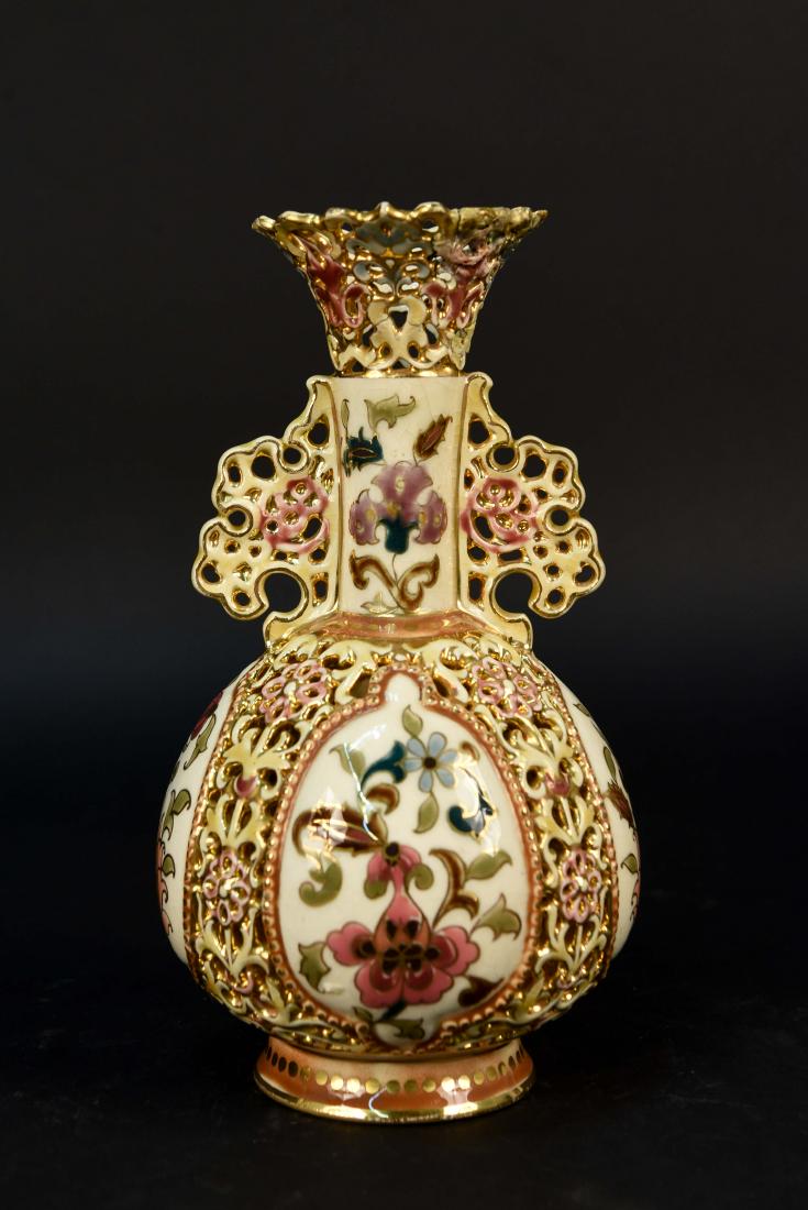 ZSOLNAY PECS PAINTED PIERCED PORCELAIN VASE: Dimensions: H 8" x Dia. 4.5" Condition: Repair to top. Crazing. Finish loss.