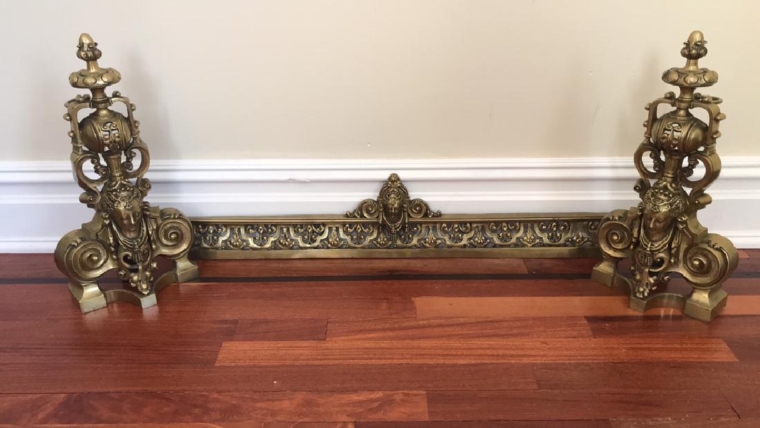 BRASS FIREPLACE ANDIRONS AND FENDER: Dimensions: H 17" x D 5" Expands to 48" Condition: Pitting