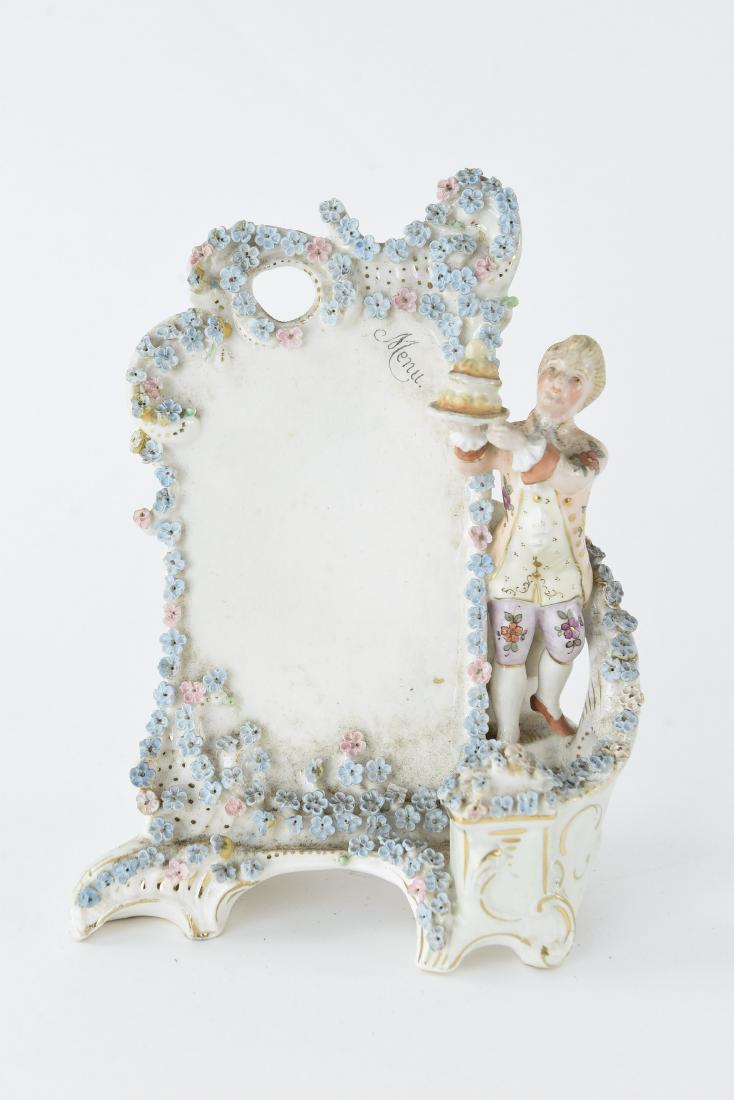 GERMAN PORCELAIN FIGURAL MENU PLACARD: Dimensions: H 6.25" x W 5.5" x D 2.75" Condition: Small losses to flowers.