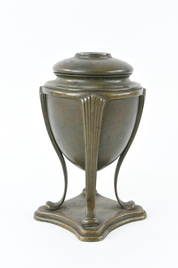 TIFFANY STUDIOS BRONZE "GREEK URN" LAMP BASE: Marked 13 Tiffany Studios New York 889. Featuring four reeded legs with pad feet on a stepped quatrefoil base Dimensions: H 8" x Dia 4" Condition: Slight bend to edge of base.