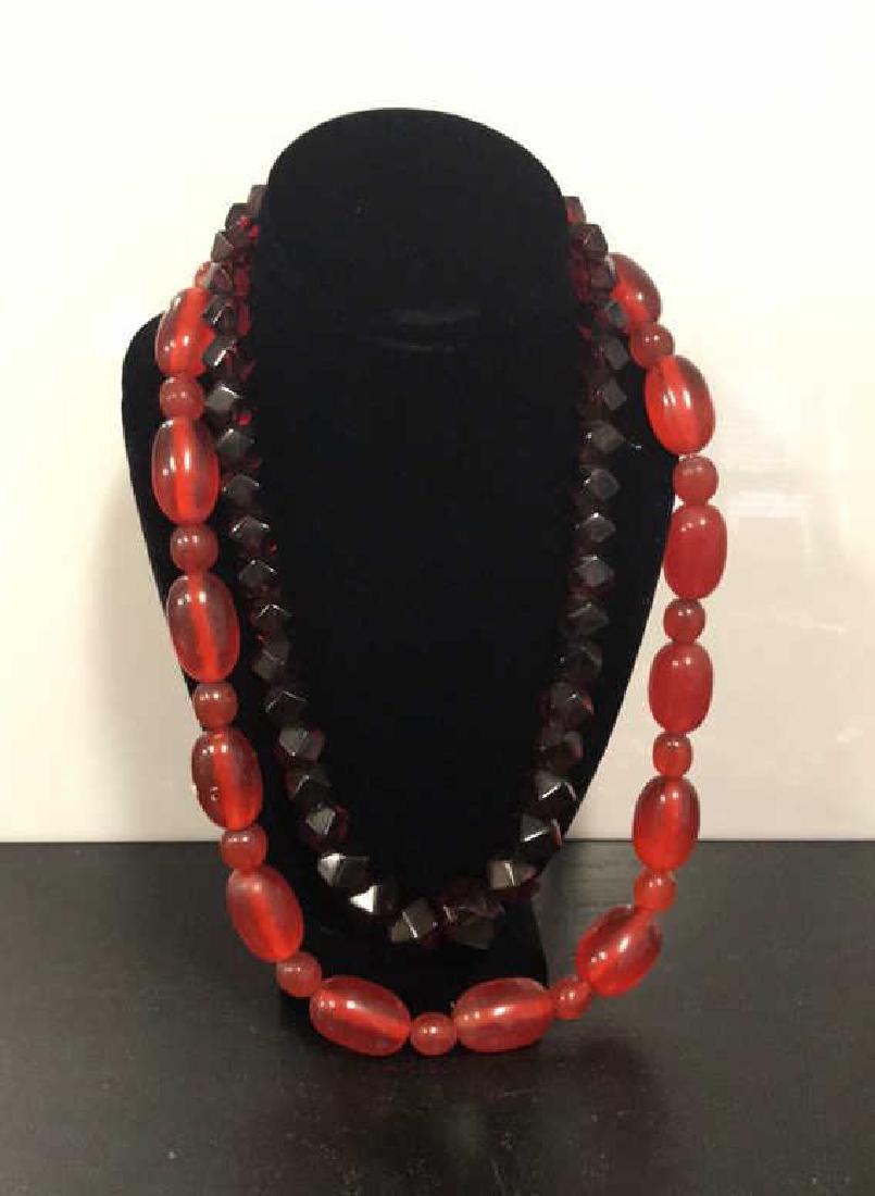 NECKLACE GROUPING INCLDUING BAKELITE: Including plastic cubist geometric bakelite necklace and plastic necklace. Dimensions: Bakelite: L 23" Condition: Bakelite necklace needs to be restrung