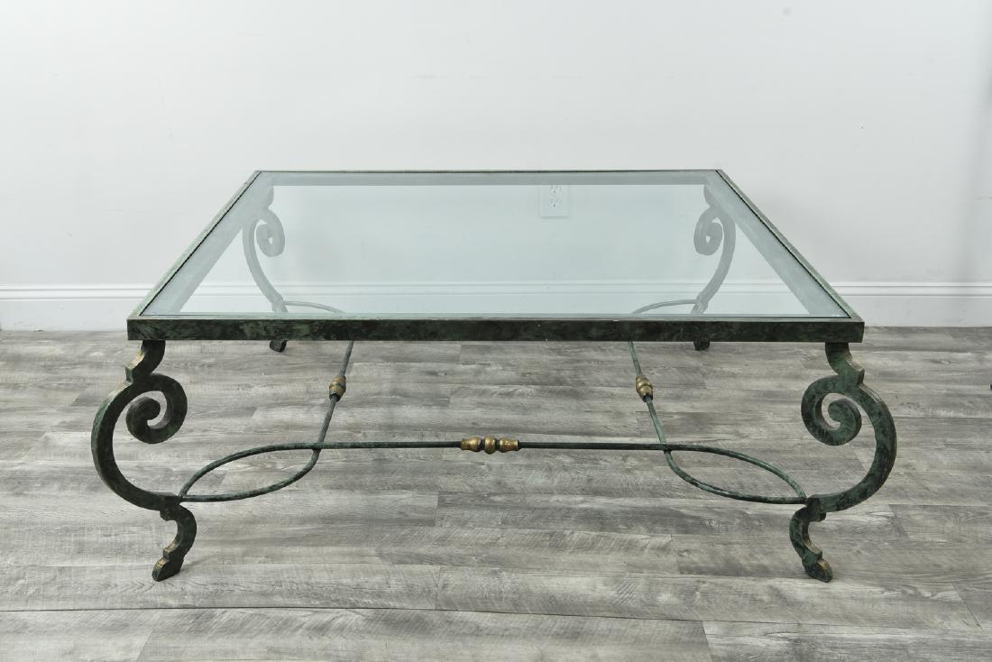 IRON AND GLASS COFFEE TABLE: Dimensions: H 19.5" x W 46.5" x D 46.5" Condition: Some residue. Light surface scratches. Few small scallop chips to edges of glass.