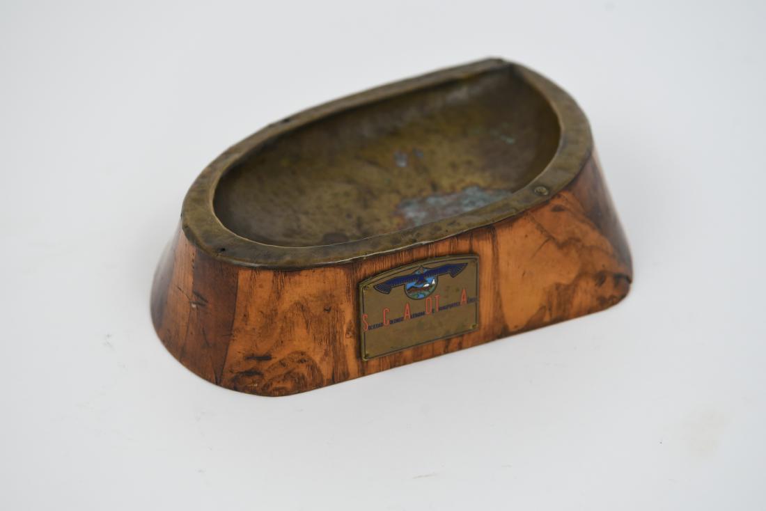 AVIATION ASHTRAY CARVED FROM WOODEN PROPELLOR: DImension: 2.25"H x 8.75" W Condition: Some tarnish to metal insert, one area with loss of wood. Plaque on front reads: Sociedad Colombo Alemana De Transportrd Aeros