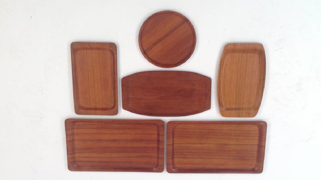 TEAK TRAY GROUPING: Six total, Denmark/Sweden 1960's. Dimensions: (Largest) L 22" x W 13" Condition: Slight warp to a couple.
