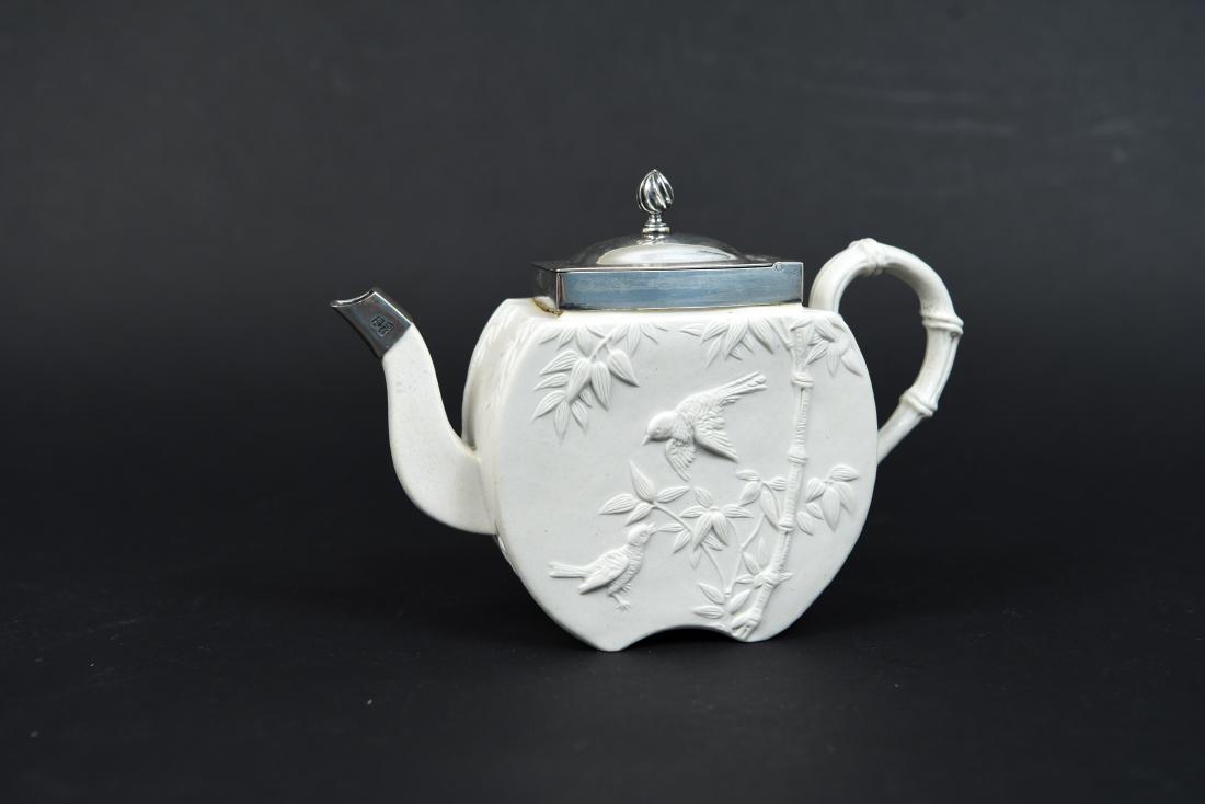 COPELAND 1880 WHITE SMEAR GLAZE EARTHENWARE TEAPOT: Copeland c. 1880, white smear glazed earthenware. With sterling silver lid and spout tip, hallmarked. Marked Copeland underneath. Raised regular mark. Dimensions: H 6" x W 8.25" x D 2.5" Condition: Po