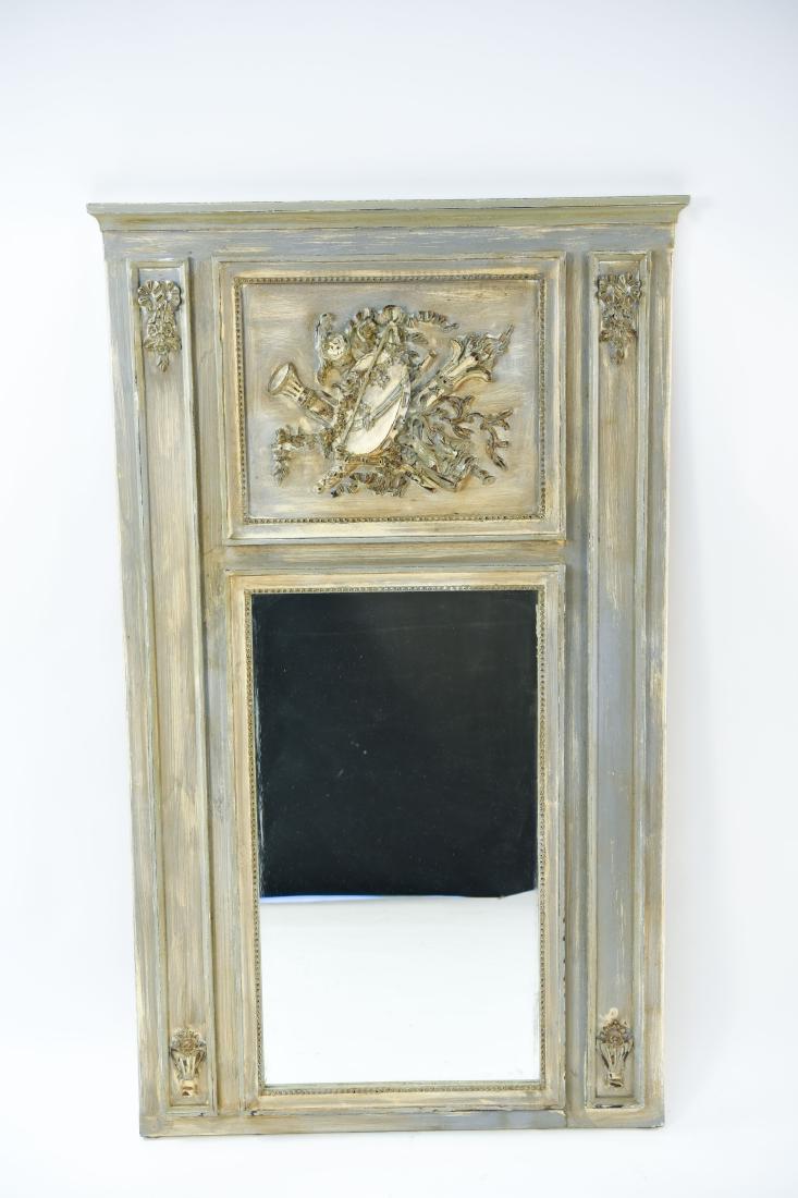 18TH CENTURY STYLE TRUMEAU MIRROR: With music motif. Antiqued finish. Dimensions: H 61.5" x W 37" Condition: No issues to note.