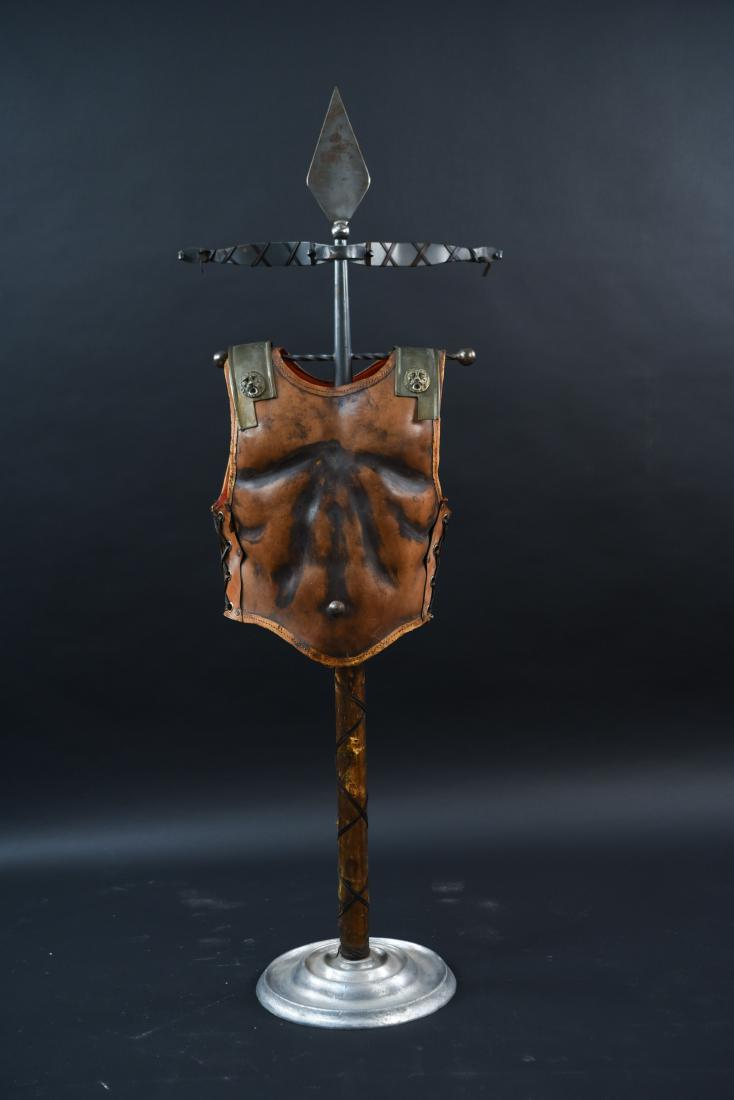 ITALIAN GLADIATOR LEATHER ARMOR VALET: Dimensions: H 58" x W 21" x D 14" Condition: Some surface scratches and rust to metal. Surface wear, slight discoloration, and few small cracks to leather. Surface wear and losses to center pole.