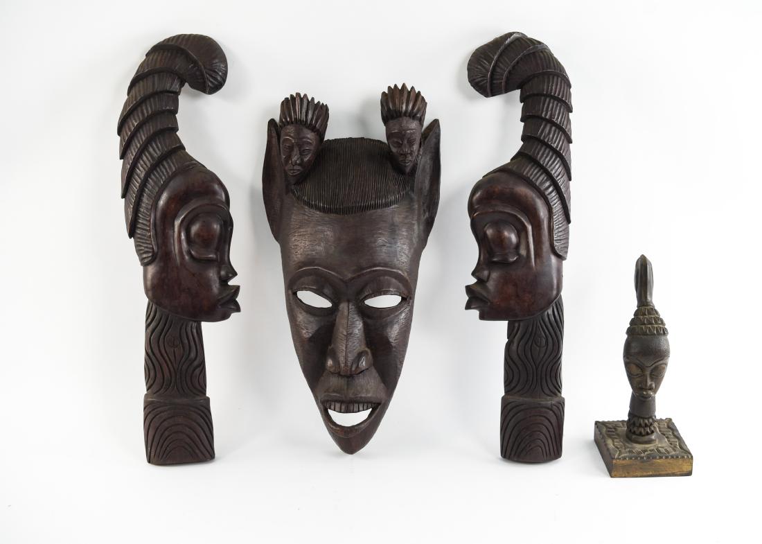 GROUPING OF HAITIAN CARVED WOODEN MASKS: (4) pieces. Dimensions: (Largest) H 25" x W 13" x D 4.5" Condition: Crack to largest. Some finish wear. Few minor scuffs and scratches.