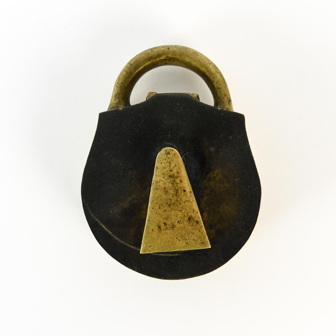 SCULPTURAL BRASS LOCK BOX: Unsigned. Dimensions: H 1.25" x W 4.75" x D 3.75" Condition: Showing wear consistent with age and use. Surface scratches and dings.