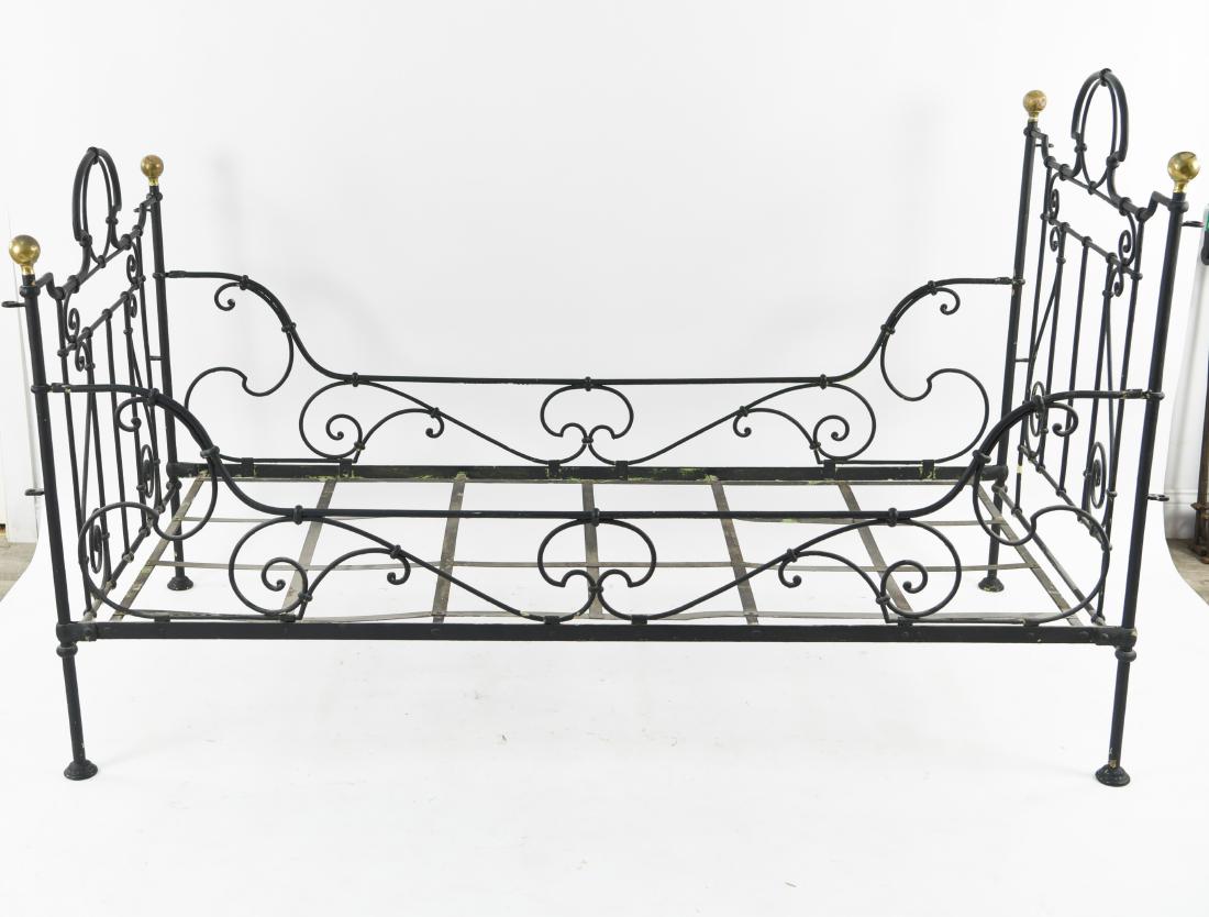 VICTORIAN IRON DAYBED: With brass finials. Dimensions: H 44.75" x W 73" x D 35.5" Condition: Many paint layers.
