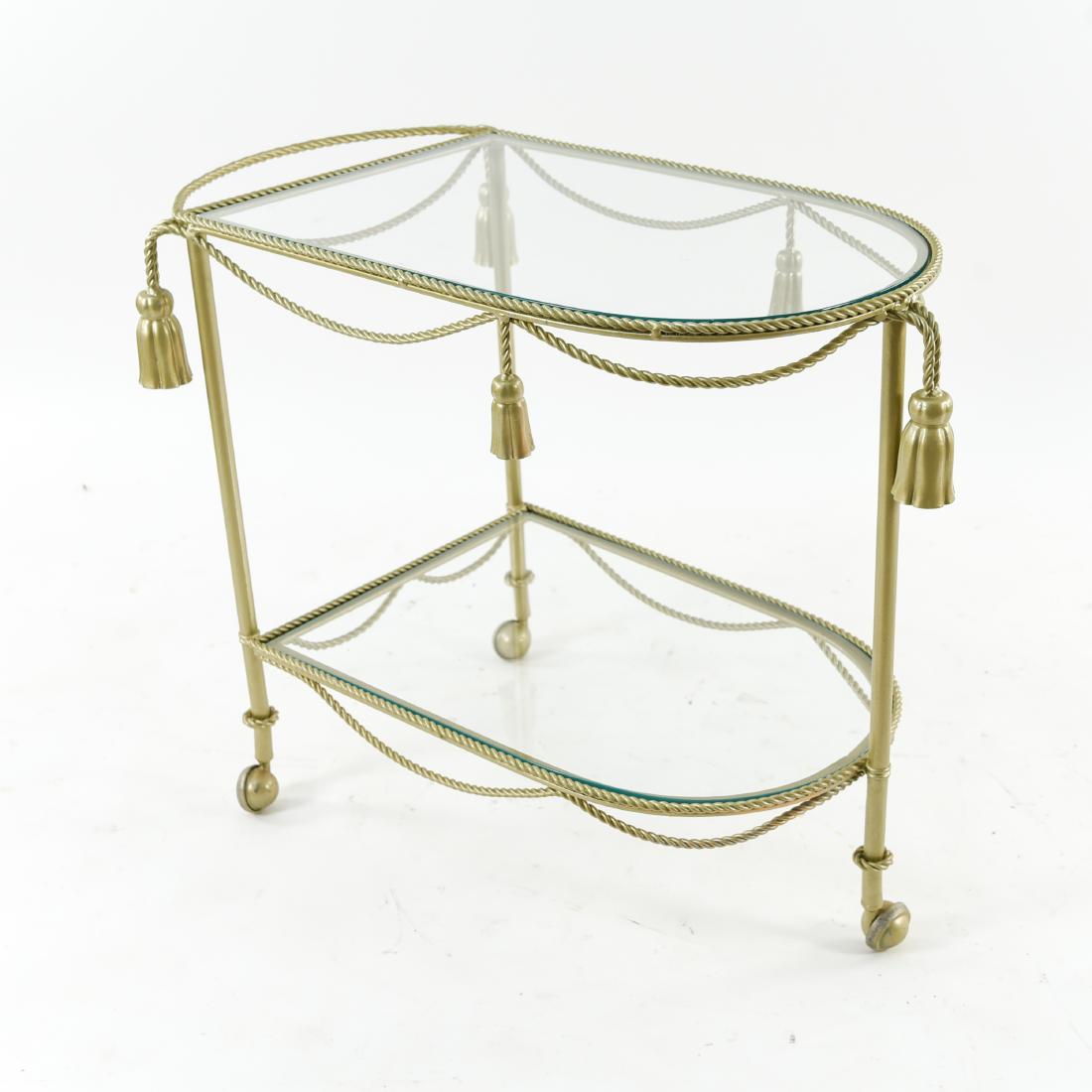 HOLLYWOOD REGENCY TASSEL BAR CART: Dimensions: H 25.5" x W 29.25" x D 19.25" Condition: Some paint chipping. Chips and scratches to glass.