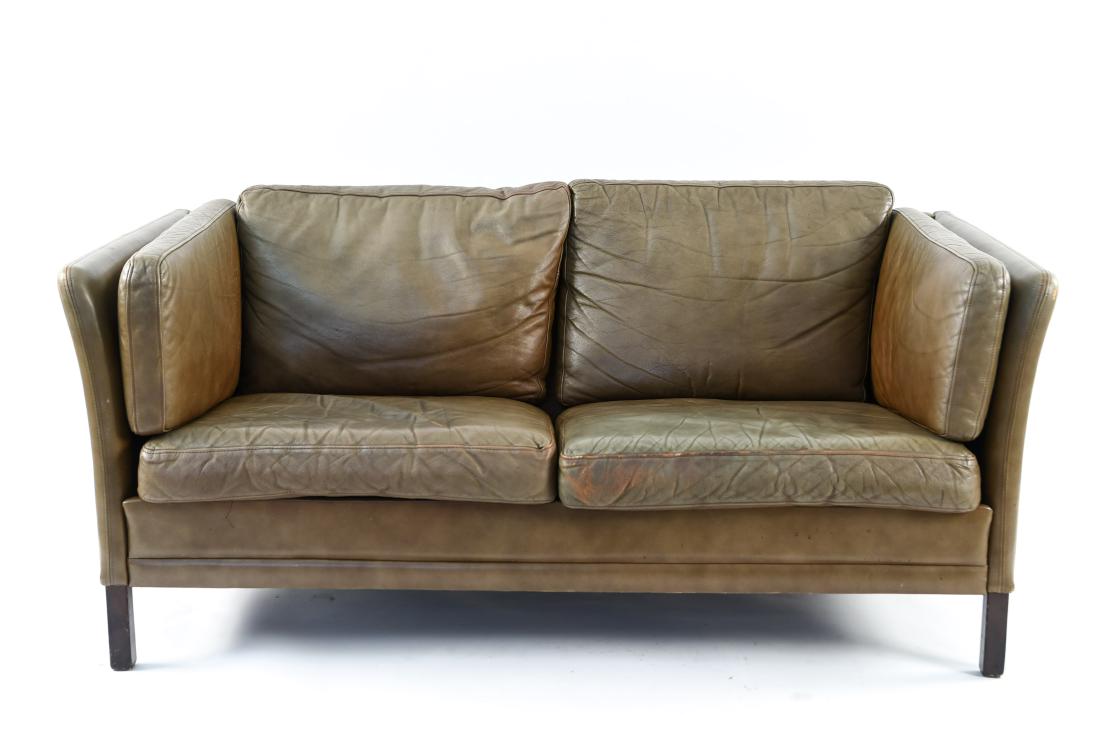 DANISH LEATHER SOFA BY MOGENS HANSEN, 1960S: Dimensions: H 26" x W 58.5" x D 31" x SH 16" Condition: Few scuffs and scrapes to corners of legs and leather. Wear consistent with age and use. WPC031-B