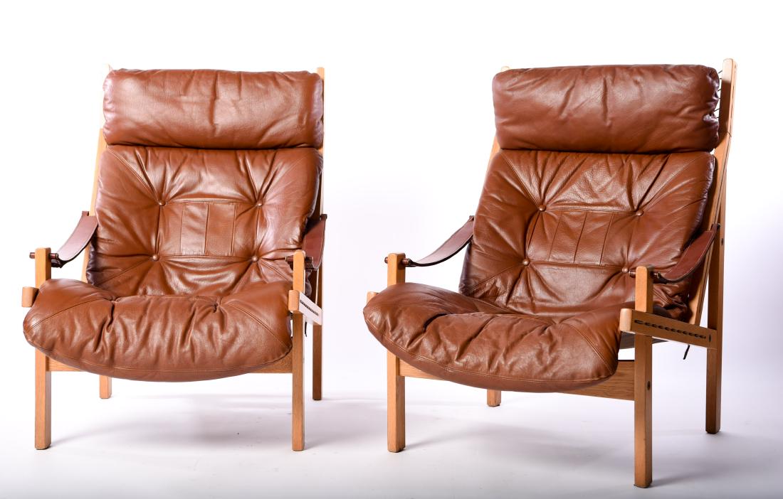 PAIR TORBJORN AFDAL, BRUKSBO NORWAY CHAIRS: Hunter lounge chairs, c. 1960s. Dimensions: H 37.5" x W 26" x D 29.5" x SH 16" Condition: Some fading to canvas backs. Light wear to wood. Wear consistent with age and use. WPC014
