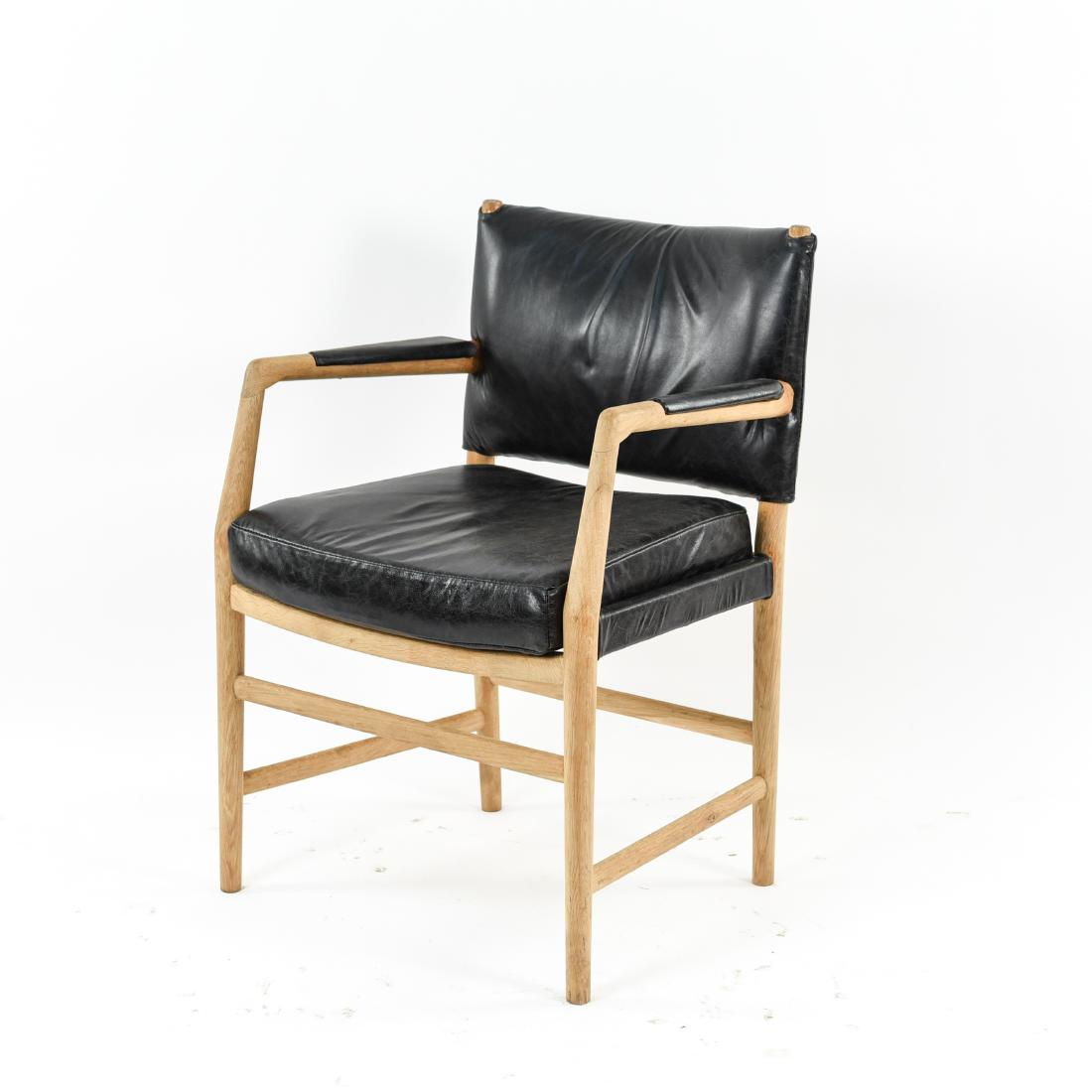 HANS J. WEGNER AARHUS CITY HALL CHAIR: Black leather. Dimensions: H 34" x W 22.75" x D 22" x SH 20.5" Condition: Wear to leather. Dent to leather on top of backrest. Few stains to wood. Wear consistent with age and use. WPC048