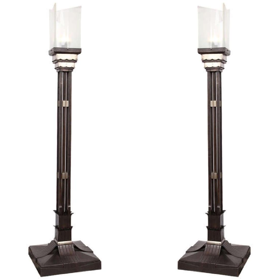 PAIR OF MONUMENTAL, 1920S ART DECO TORCHERES: Attributed to Walter Kantack, handcrafted of wrought iron and polished nickel, with ground glass shades. C. 1920s.Dimensions: H 81" x W 19" x D 19"Condition: Good, some scallop chips to shades, not te