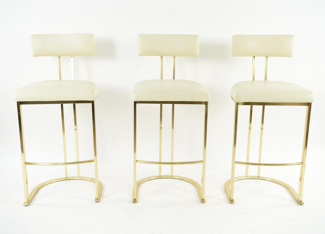 (3) DIA MODERN BRASS BAR STOOLS: Dimensions: H 42.25" x W 18.75" x D 19" x SH 29" Condition: Small hole to one's upholstery. Few scuffs to upholstery.