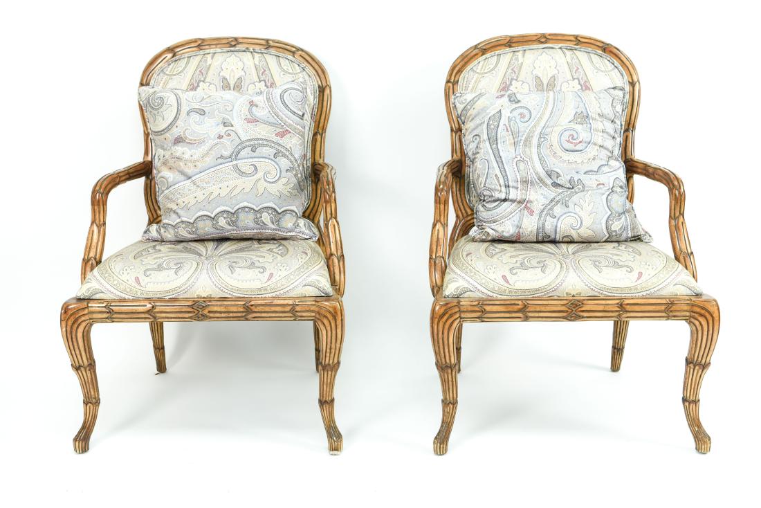 PAIR OF ARM CHAIRS MANNER OF SERGE ROCHE: Pair of carved leaf chairs recently recovered in paisley with a matching pair of toss pillows. Dimensions: H 38.5" x W 26" x D 21" x SH 17.5" Condition: Showing light wear consistent with age and use.