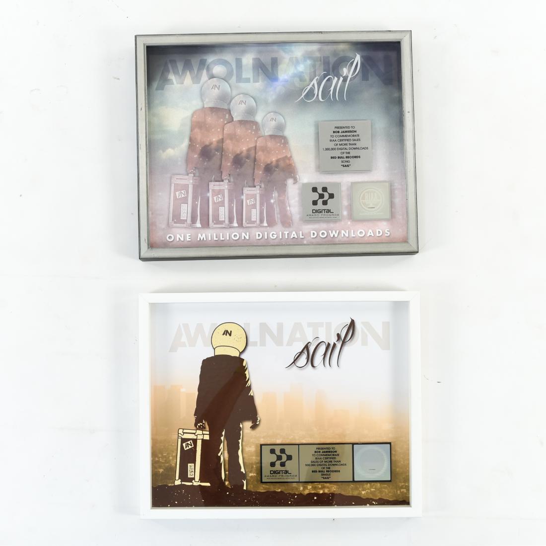 (2) SALES AWARDS AWOLNATION SAIL DIGITAL DOWNLOADS: Bull Records, "Sail." Presented to Bob Jamieson. Certified sales awards for more than 500,000 and 1 million digital downloads, respectively.Dimensions: (Frame) H 17" x W 21"Condition: Showing light we