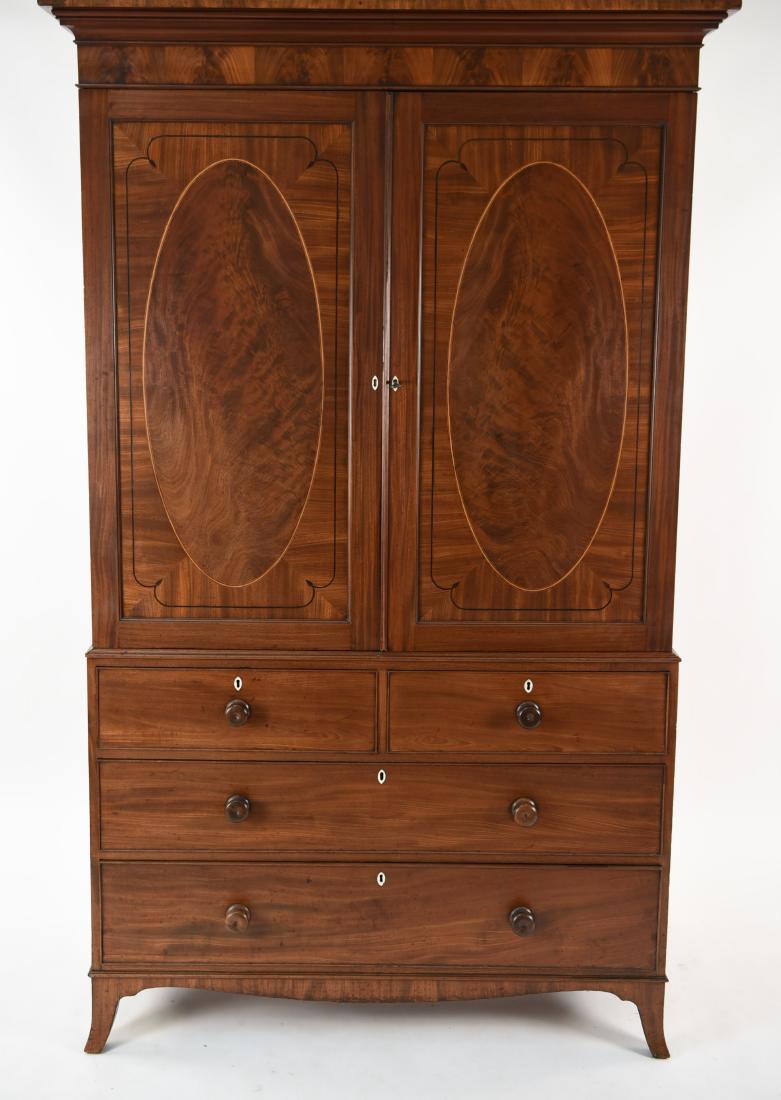 GEORGE IV INLAID MAHAGONY LINEN PRESS CABINET: Flame mahogany with bone key holes. Satin and rosewood inlay. 2 pieces. Top with open drawers. Bottom half 2 over 2 drawers. Dimensions: H 85" x W 48" x D 22" Condition: Few shallow scattered scratche