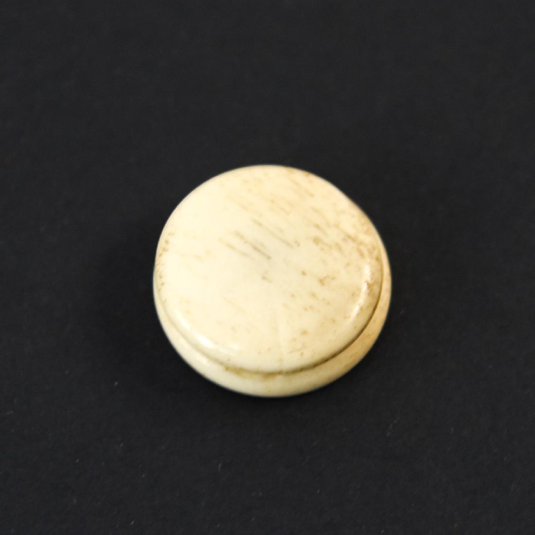 BONE MEDICINE CONTAINER: With John Wyeth and Bro. sticker underneath. Dimensions: H .25" x Dia. 1" Condition: Light surface wear from age and use.
