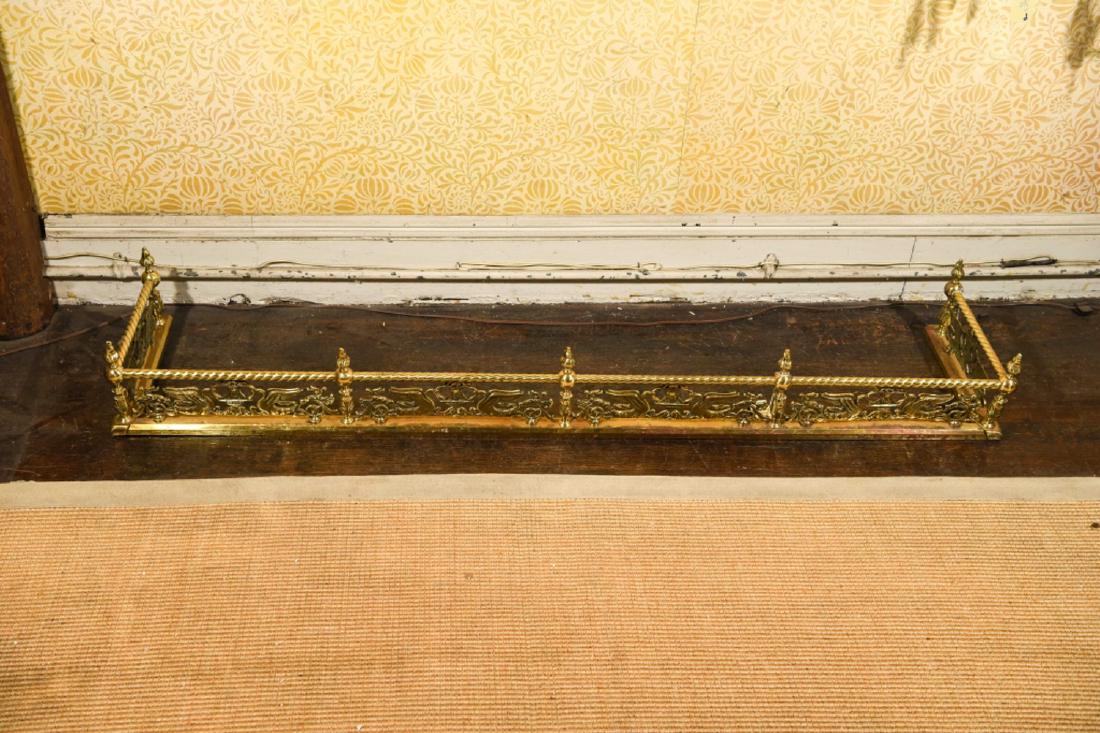 CIRCA 1920S BRASS FIRE FENDER: Dimensions: H 7.5" x W 58" x D 12" Condition: Surface pitting.