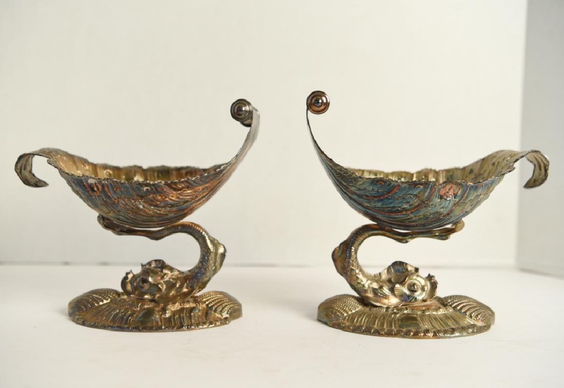 PAIR OF ANTIQUE SILVER WAVE FORM CENTERPIECES: Weighted base. With dolphin support. Apparently unmarked. 19th century. Dimensions: H 7" x W 7.25" x D 5.25" Condition: Tarnish.
