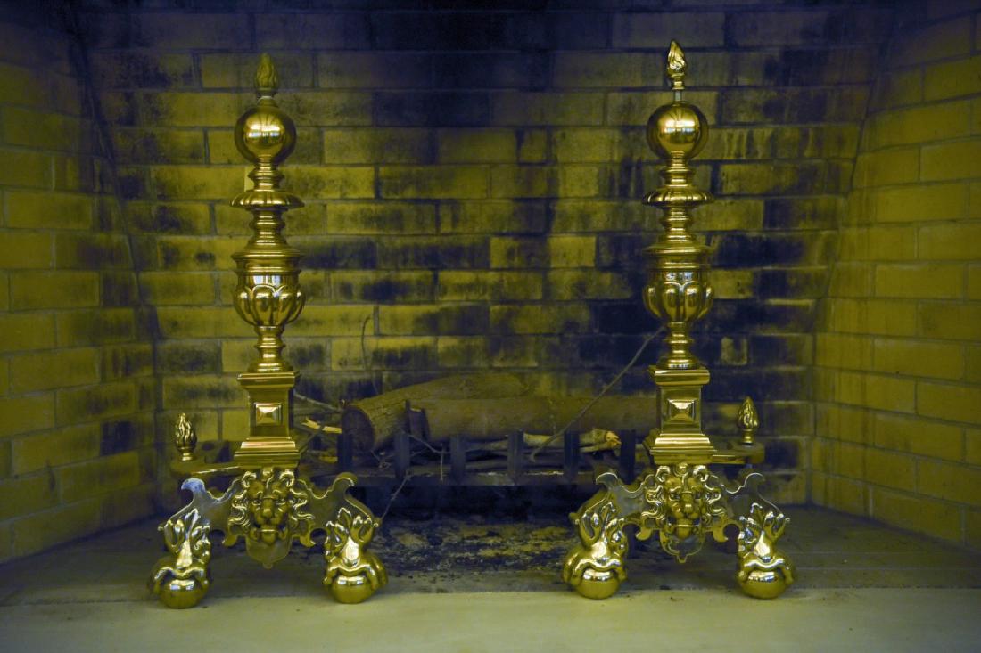 20TH C. BRASS ANDIRONS WITH LIONS HEAD: Dimensions: H 33.5" x W 14" x D 28" Condition: One finial appears to be cross thread. Other finial's finish does not match.