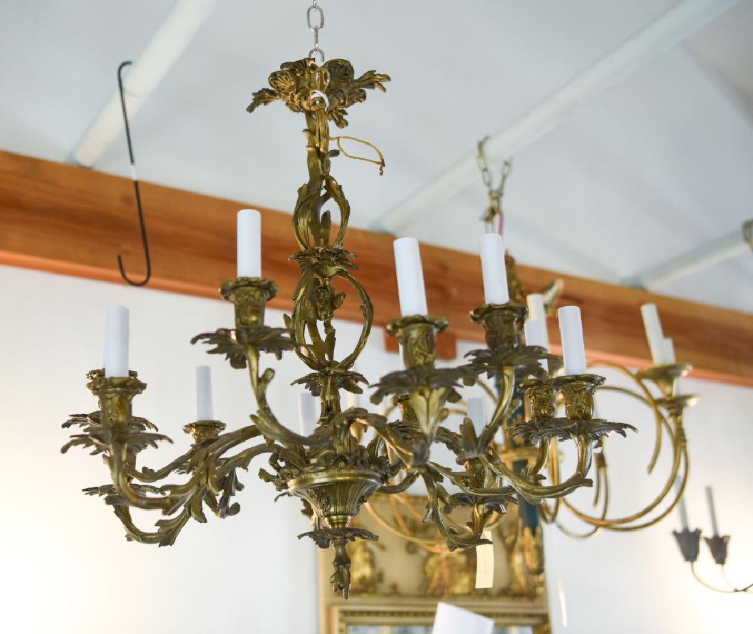 VINTAGE ROCOCO STYLE BRASS CHANDELIER: 12-light. Antiqued finish. Dimensions: H 25" x Dia. 26" Condition: No issues to note.