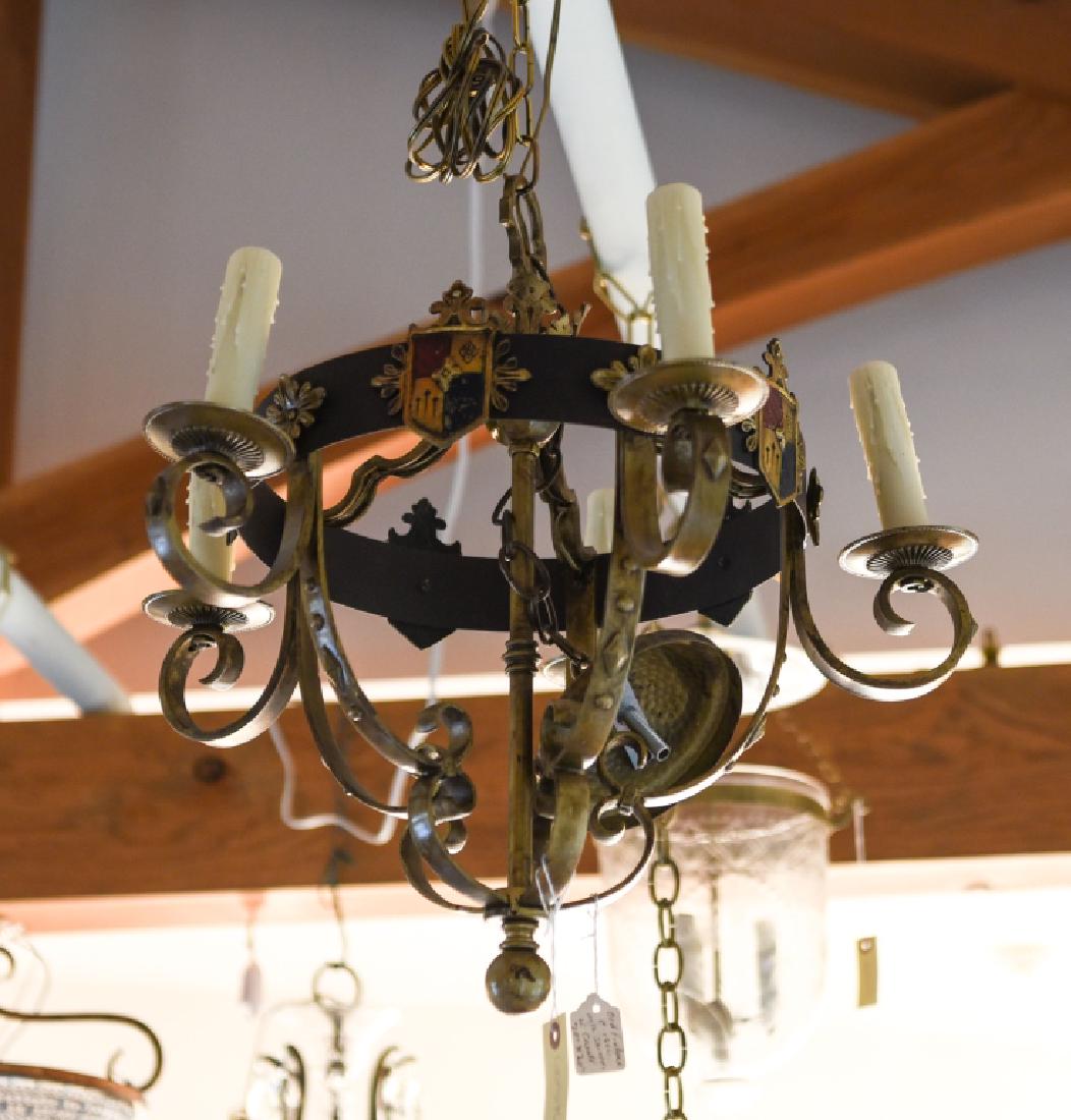 RENAISSANCE REVIVAL PATINATED METAL CHANDELIER: 5-light. With colored shields. 1920s. Dimensions: H 21" x Dia. 20" Condition: With intentionally antiqued finish.