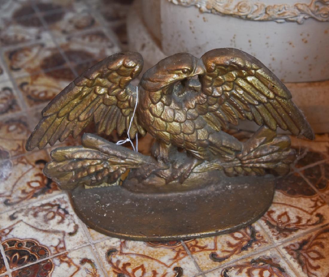 20TH C. CAST IRON EAGLE DOORSTOP: Old gold paint. Dimensions: H 7.5" x W 12.5" x D 3.5" Condition: Some rust.