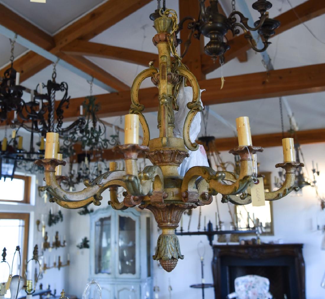 SPANISH REVIVALPAINTED CARVED WOOD CHANDELIER: Vintage. Antiqued surface. Dimensions: H 35" x Dia. 34" Condition: A few rubs. Rewired.