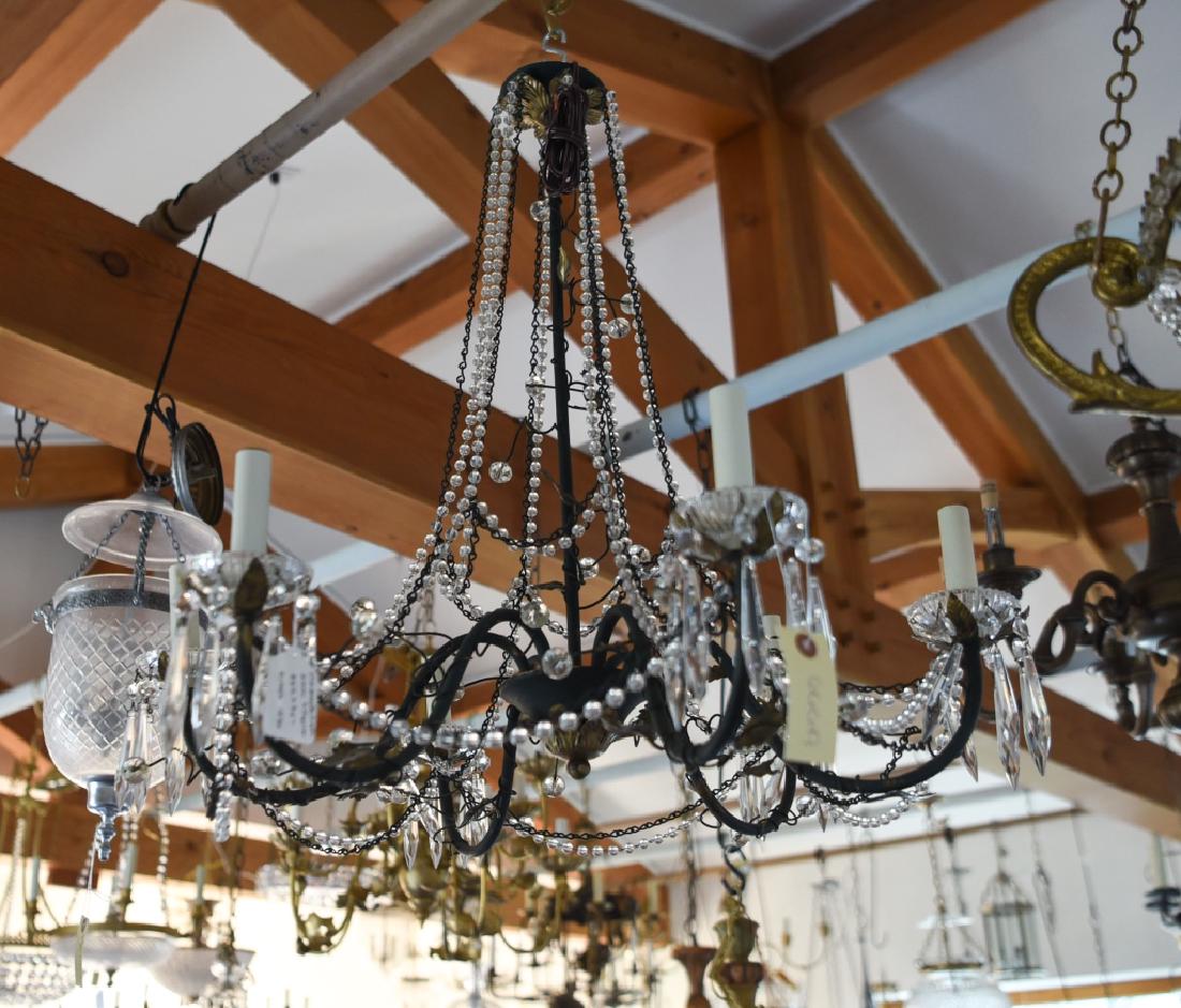 VINTAGE EMPIRE STYLE METAL & CRYSTAL CHANDELIER: Green painted with gold antiqued details. Dimensions: H 28" x Dia. 27" Condition: Some rubs to paint finish.