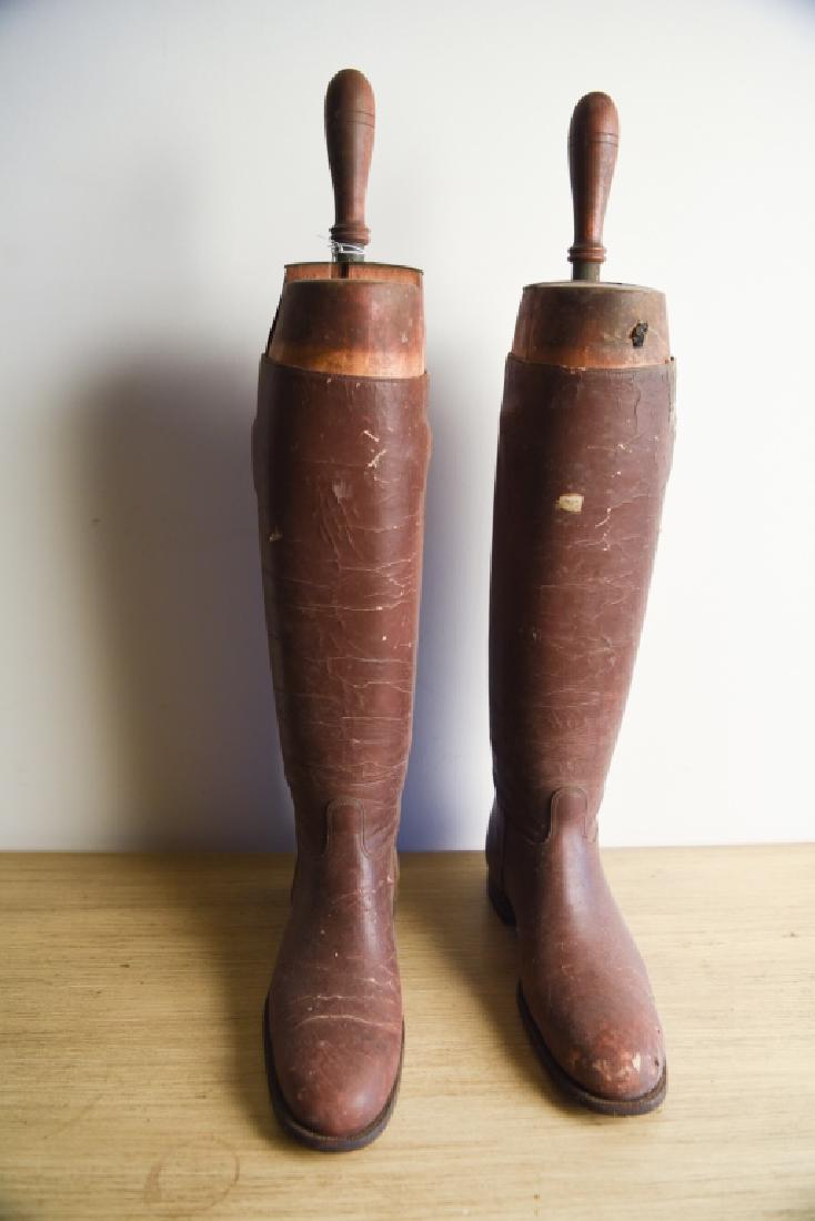 PAIR OF ANTIQUE BOOT STRETCHERS: Wood with handles. Vintage leather boots attached. Dimensions: H 25" x W 12" x D 4.75" Condition: As is.
