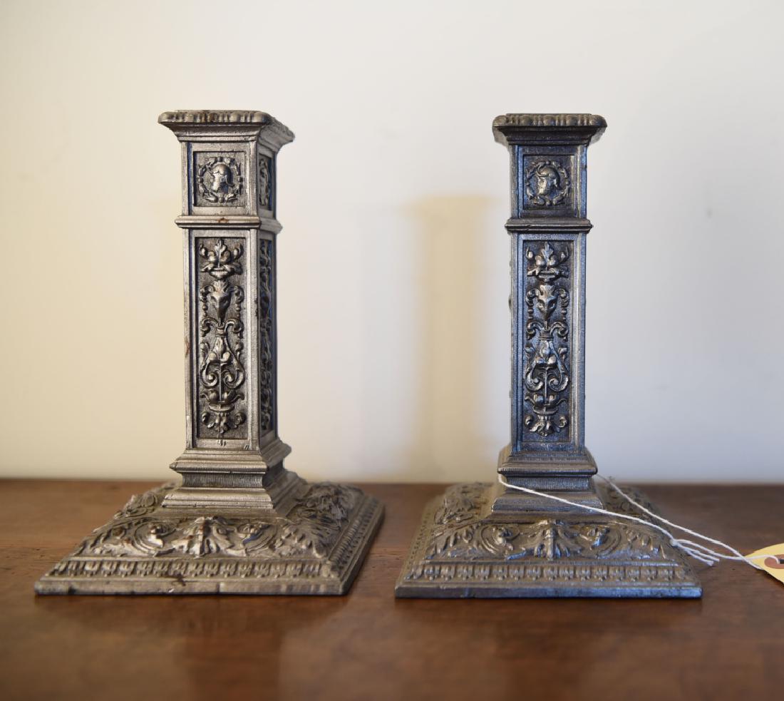 PAIR CONTEMPORARY RENAISSANCE STYLE CANDLESTICKS: Faux pewter finish. Dimensions: H 8" x W 4.5" x D 4.5" Condition: Couple spots of surface discoloration.