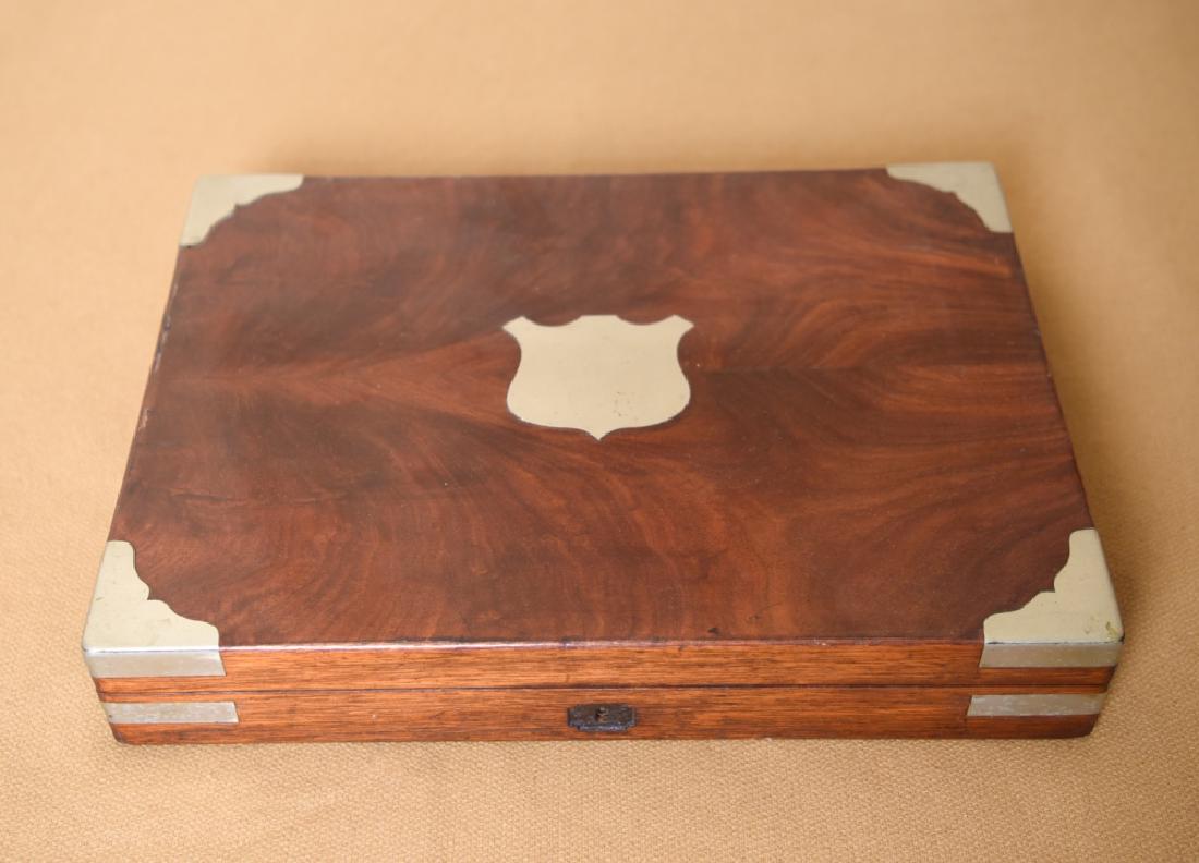19TH C. WOODEN BOX: With silverplated detail. In Campaign style. Dimensions: H 3" x W 16.5" x D 11.75" Condition: Some edge chips to veneer. Missing escutcheon.
