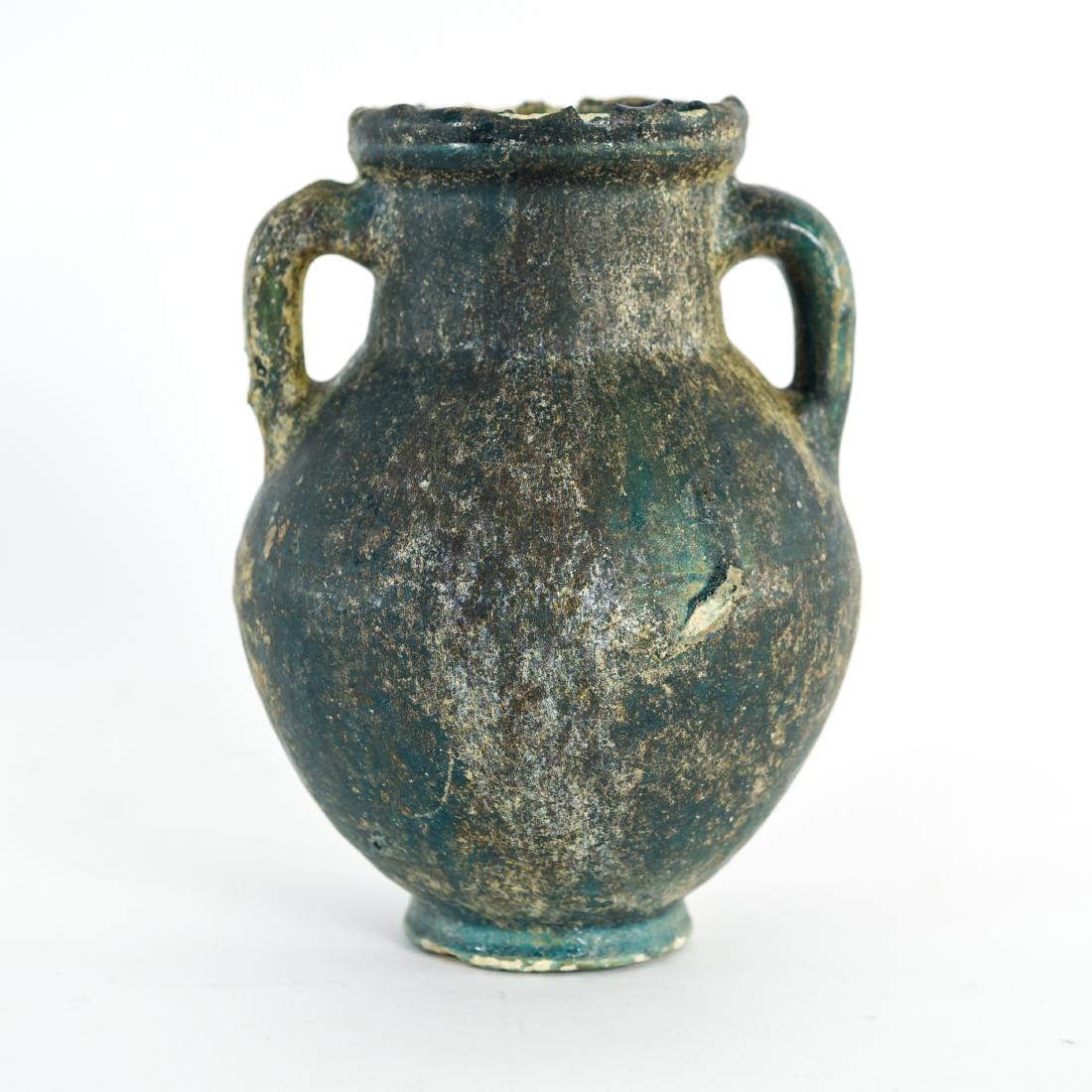 ISLAMIC KASHAN BALUSTER VASE 11/12TH C.: Green glaze with burial iridescence. Dimensions: H 9" x Dia. 7" Condition: Chips and losses to rim and base. Unbroken, unrestored.