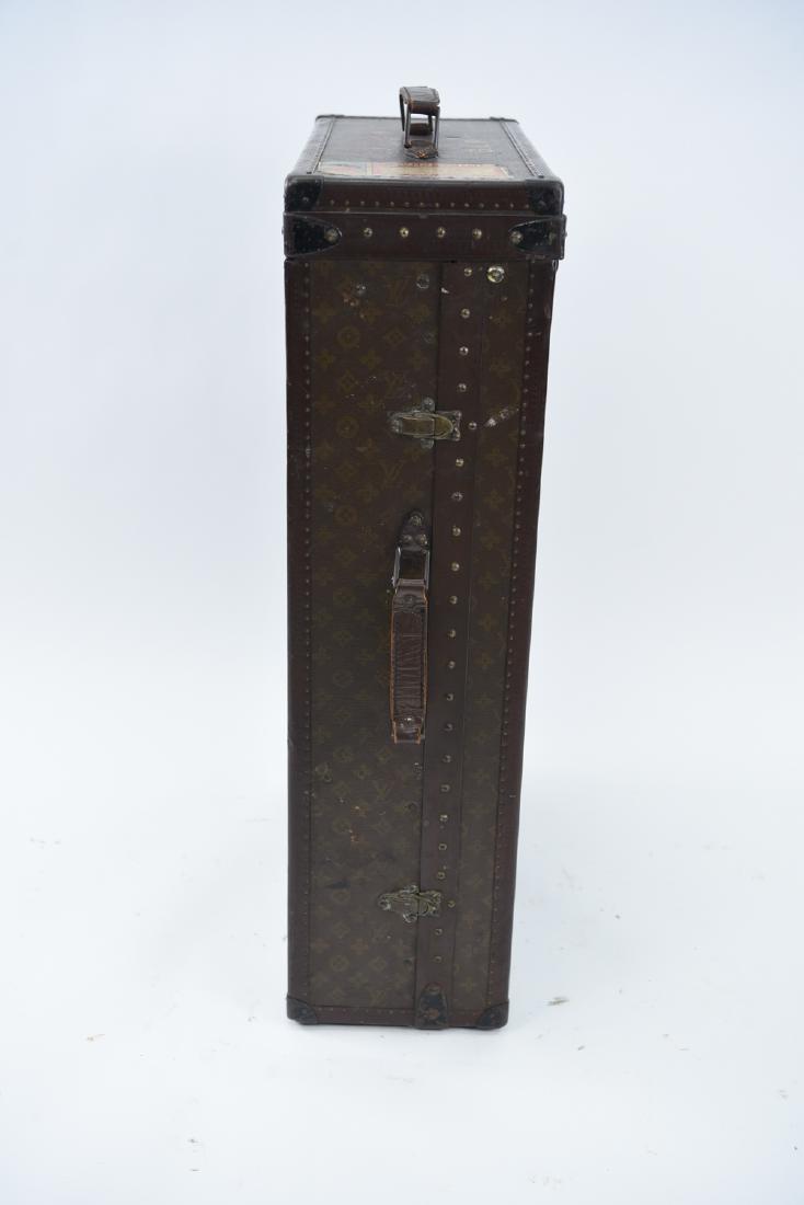 MINIATURE LOUIS VUITTON STEAMER WARDROBE TRUNK: Marked on hardware and exterior. Dimensions: (Upright) H 35" x W 22" x D 9+" Condition: Showing some light wear to exterior. Some scuffs and label remnants. Light wear to interior.