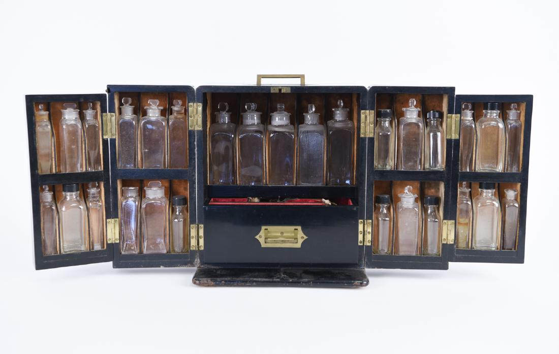 19TH C. ENGLISH PORTABLE MEDICAL APOTHECARY CHEST: Ebonized with brass fittings. Complete with bottles. Some with glass stoppers, some with plastic stoppers. Center drawer opens to reveal scale set and key. Dimensions: (Closed) H 11" x W 10.75" x D 8"